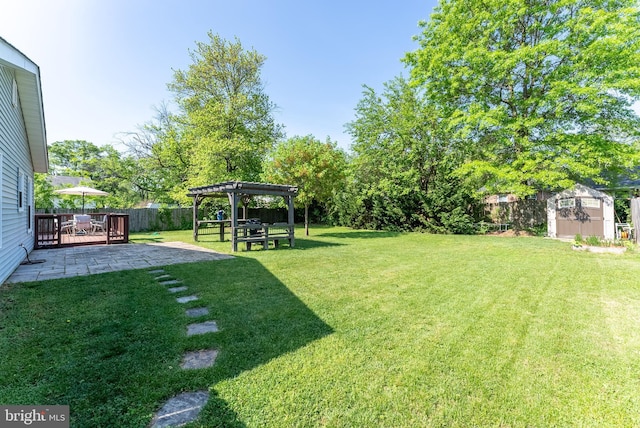 view of yard featuring an outdoor structure, a pergola, a fenced backyard, a shed, and a patio area