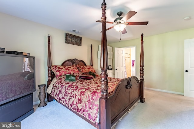 bedroom with light colored carpet, a ceiling fan, baseboards, and visible vents
