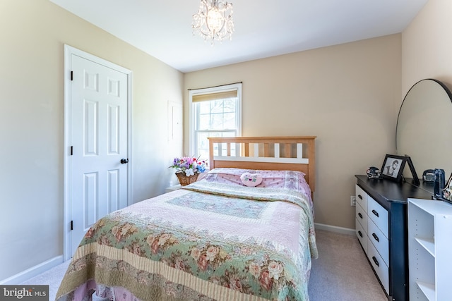 bedroom with an inviting chandelier, baseboards, and light colored carpet