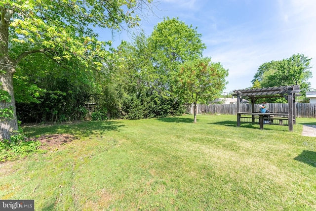 view of yard featuring a fenced backyard and a pergola