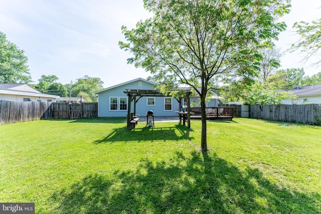 view of yard featuring a pergola, a fenced backyard, and a deck