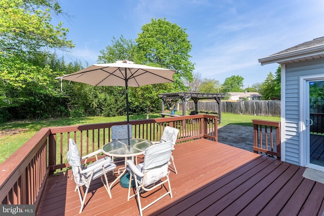 wooden deck featuring a fenced backyard, a pergola, outdoor dining area, and a yard