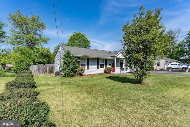 view of front of house with aphalt driveway, fence, and a front yard