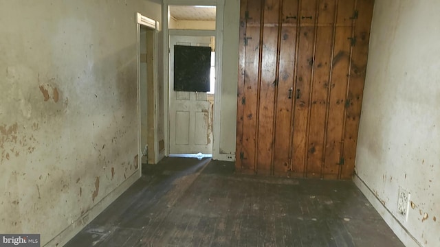 spare room featuring wood-type flooring