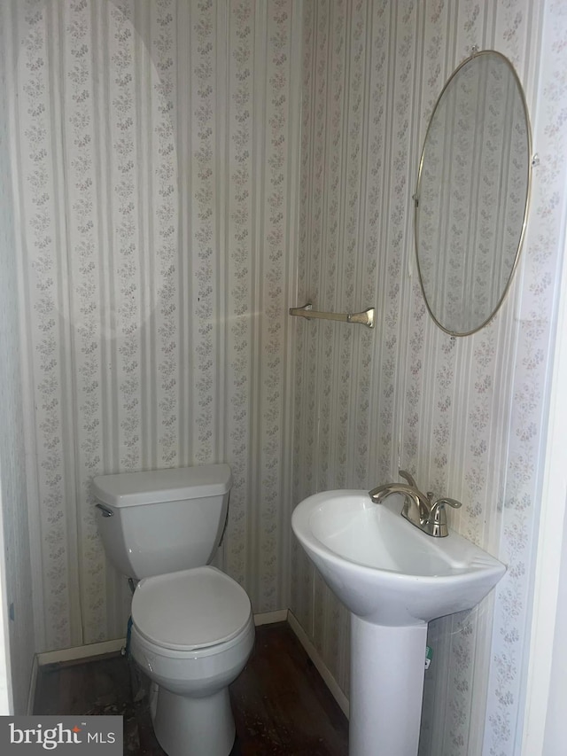 bathroom with baseboards and toilet
