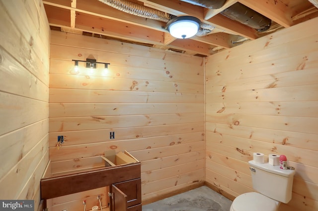 5560 Hideaway Ln, Todd, PA 16685 - bathroom featuring unfinished concrete flooring, toilet, and wooden walls