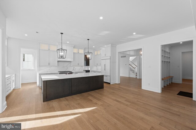 kitchen featuring light countertops, recessed lighting, white cabinetry, and paneled fridge
