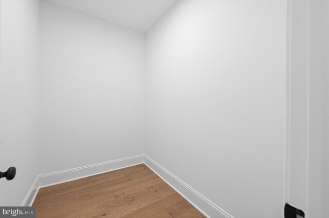 empty room with baseboards and wood finished floors