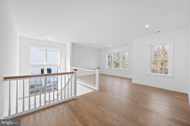 spare room featuring baseboards, recessed lighting, wood finished floors, and visible vents