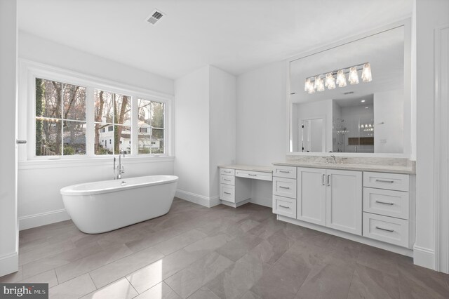 full bathroom featuring visible vents, a stall shower, vanity, baseboards, and a soaking tub