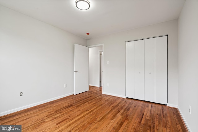 2192 Golf Course Dr, Reston, VA 20191 - unfurnished bedroom featuring wood finished floors, baseboards, and a closet