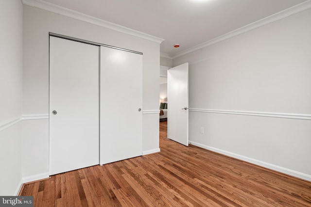 2192 Golf Course Dr, Reston, VA 20191 - unfurnished bedroom featuring ornamental molding, wood finished floors, a closet, and baseboards