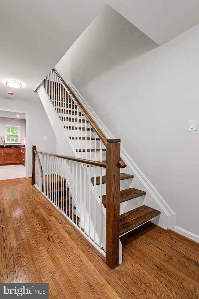 2192 Golf Course Dr, Reston, VA 20191 - stairs featuring hardwood / wood-style flooring and baseboards