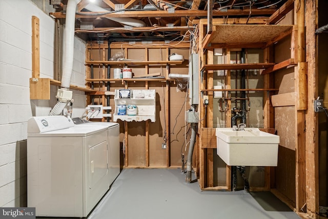 2192 Golf Course Dr, Reston, VA 20191 - unfinished below grade area with washing machine and clothes dryer, a sink, and concrete block wall