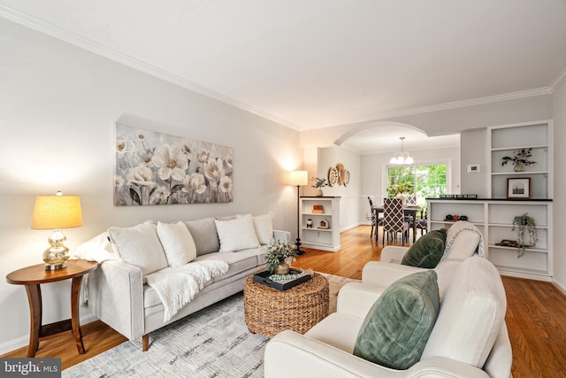 2192 Golf Course Dr, Reston, VA 20191 - living room featuring arched walkways, ornamental molding, wood finished floors, a chandelier, and baseboards