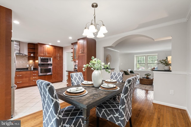 2192 Golf Course Dr, Reston, VA 20191 - dining area with arched walkways, crown molding, light wood-style floors, a chandelier, and recessed lighting