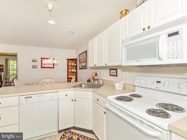 kitchen with light countertops, a sink, a peninsula, white appliances, and white cabinetry
