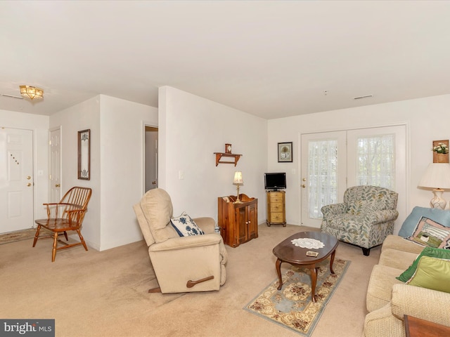 living room with baseboards and light carpet