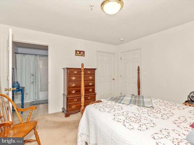 bedroom with baseboards and light colored carpet