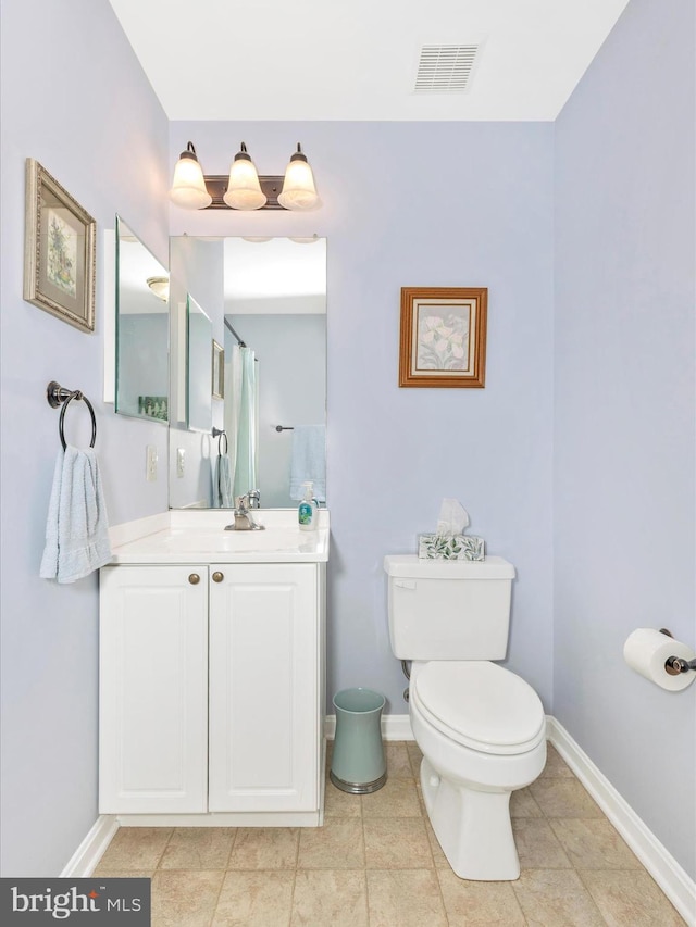 full bath with baseboards, vanity, toilet, and visible vents