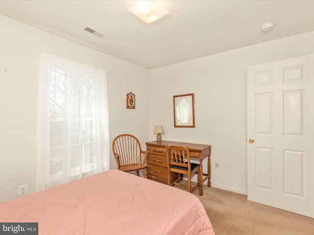 carpeted bedroom featuring visible vents