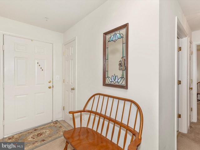 entryway featuring light carpet
