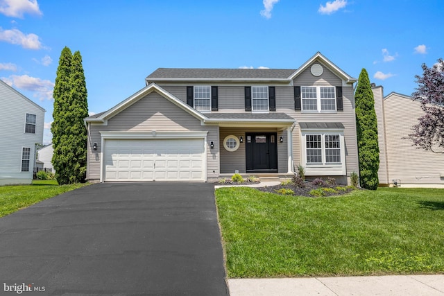 183 Mccormick Blvd, Newark, DE 19702 - traditional-style house featuring asphalt driveway, a front yard, and a garage