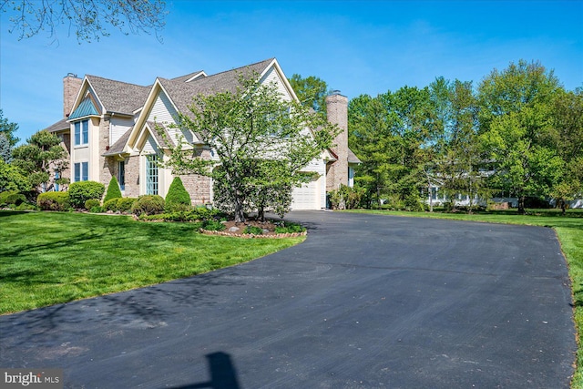 30 Revere Ct, Princeton Junction, NJ 08550 - view of front facade with a chimney, asphalt driveway, and a front yard