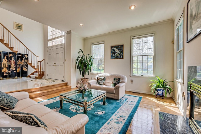 30 Revere Ct, Princeton Junction, NJ 08550 - living area featuring plenty of natural light, ornamental molding, stairs, wood finished floors, and baseboards