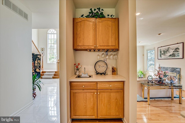 30 Revere Ct, Princeton Junction, NJ 08550 - indoor wet bar with plenty of natural light, stairway, baseboards, and light wood finished floors
