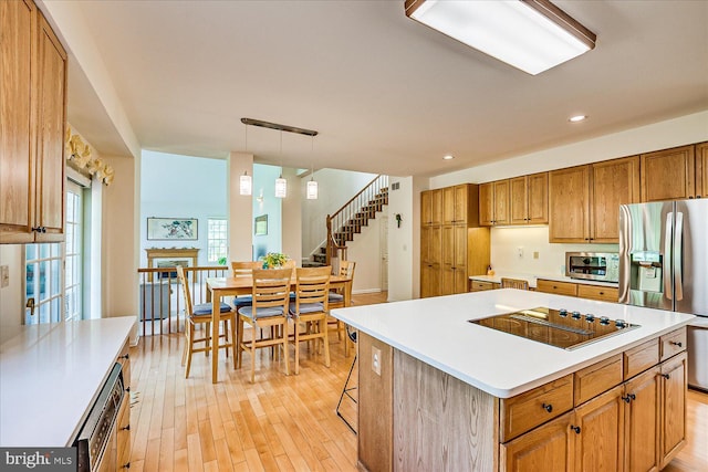 30 Revere Ct, Princeton Junction, NJ 08550 - kitchen featuring stainless steel appliances, light wood-style flooring, brown cabinetry, light countertops, and recessed lighting
