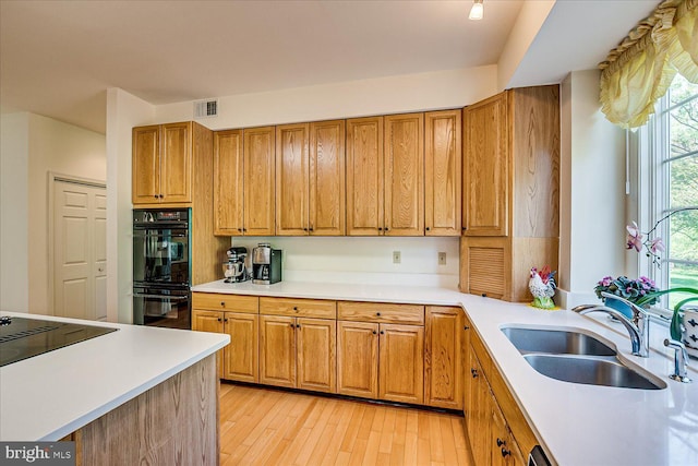 30 Revere Ct, Princeton Junction, NJ 08550 - kitchen featuring black appliances, light countertops, a sink, and brown cabinetry