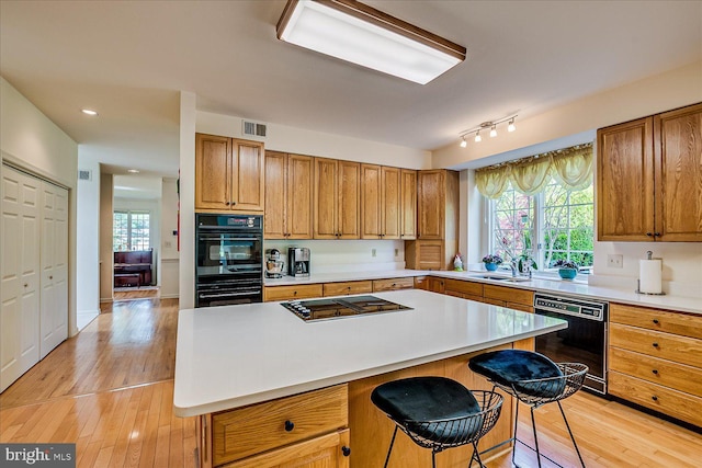 30 Revere Ct, Princeton Junction, NJ 08550 - kitchen featuring black appliances, light wood-type flooring, a sink, light countertops, and recessed lighting