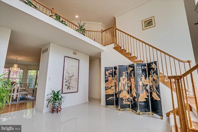 30 Revere Ct, Princeton Junction, NJ 08550 - stairs with a chandelier, tile patterned floors, baseboards, a high ceiling, and crown molding