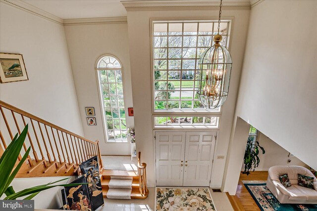 30 Revere Ct, Princeton Junction, NJ 08550 - tiled foyer entrance featuring a chandelier, stairs, crown molding, a high ceiling, and baseboards