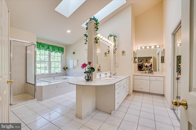 30 Revere Ct, Princeton Junction, NJ 08550 - bathroom featuring tile patterned floors, a skylight, a garden tub, vanity, and high vaulted ceiling