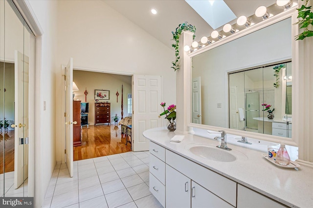 30 Revere Ct, Princeton Junction, NJ 08550 - bathroom with vanity, a skylight, tile patterned floors, high vaulted ceiling, and recessed lighting
