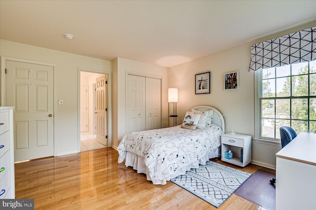 30 Revere Ct, Princeton Junction, NJ 08550 - bedroom with light wood-type flooring, a closet, and baseboards