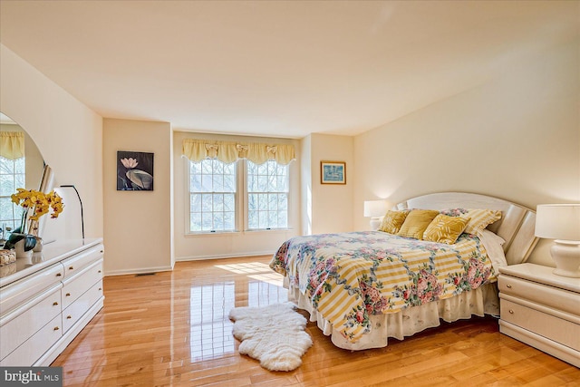 30 Revere Ct, Princeton Junction, NJ 08550 - bedroom featuring multiple windows, light wood finished floors, and arched walkways
