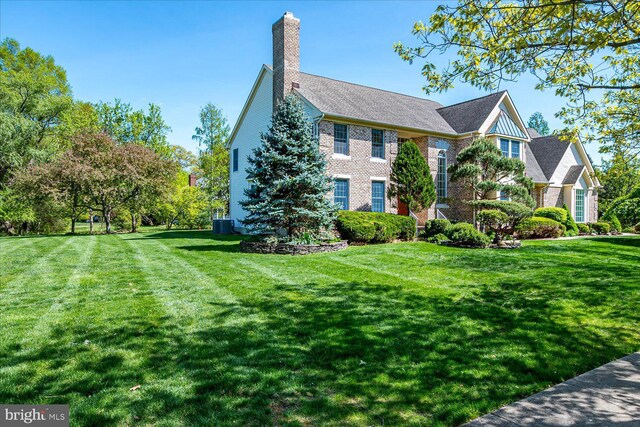 30 Revere Ct, Princeton Junction, NJ 08550 - view of front of house featuring a chimney, a front yard, and brick siding