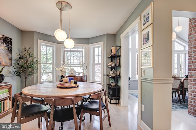 dining room with baseboards and light wood finished floors