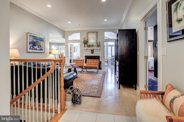 living room with crown molding, recessed lighting, baseboards, and a fireplace