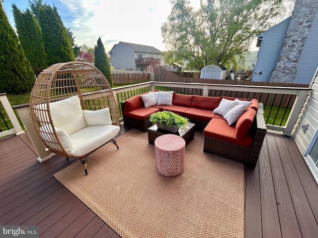 wooden deck featuring outdoor lounge area and a fenced backyard