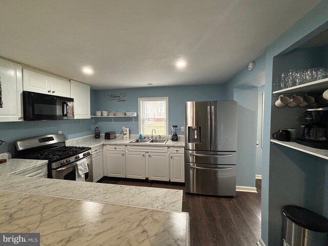 kitchen with open shelves, a sink, light countertops, stainless steel appliances, and white cabinetry