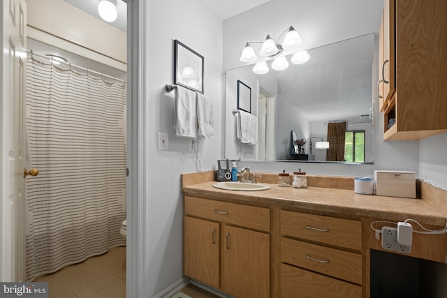 full bathroom featuring a shower with curtain, vanity, toilet, and tile patterned floors