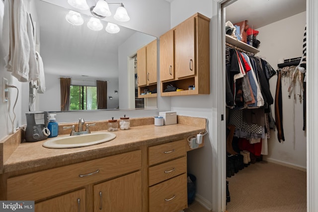 bathroom featuring vanity and a walk in closet