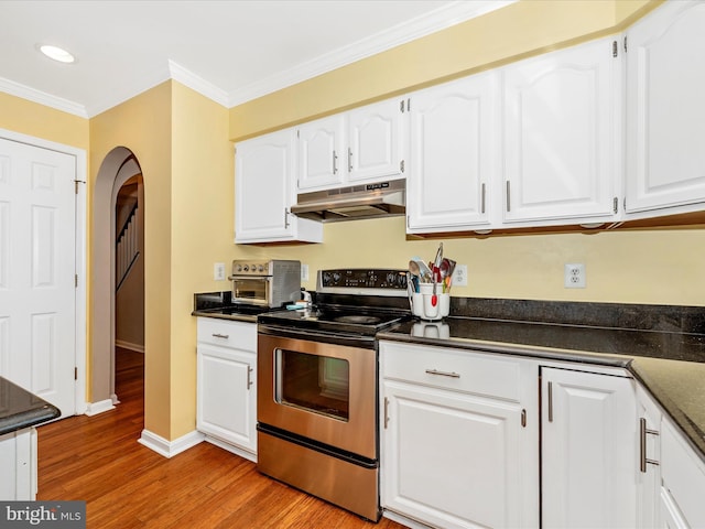 7915 Mount Pleasant Ct E, Walkersville, MD 21793 - kitchen with dark countertops, under cabinet range hood, white cabinets, light wood-style flooring, and stainless steel range with electric cooktop