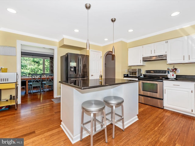 7915 Mount Pleasant Ct E, Walkersville, MD 21793 - kitchen featuring dark countertops, light wood-type flooring, under cabinet range hood, white cabinets, and appliances with stainless steel finishes