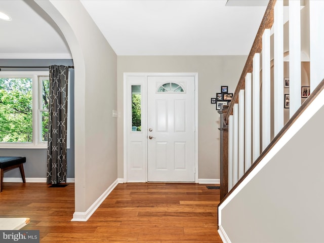 7915 Mount Pleasant Ct E, Walkersville, MD 21793 - foyer entrance with baseboards, arched walkways, light wood finished floors, and stairway