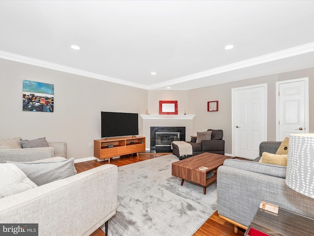 7915 Mount Pleasant Ct E, Walkersville, MD 21793 - living room featuring a fireplace with flush hearth, ornamental molding, recessed lighting, and wood finished floors
